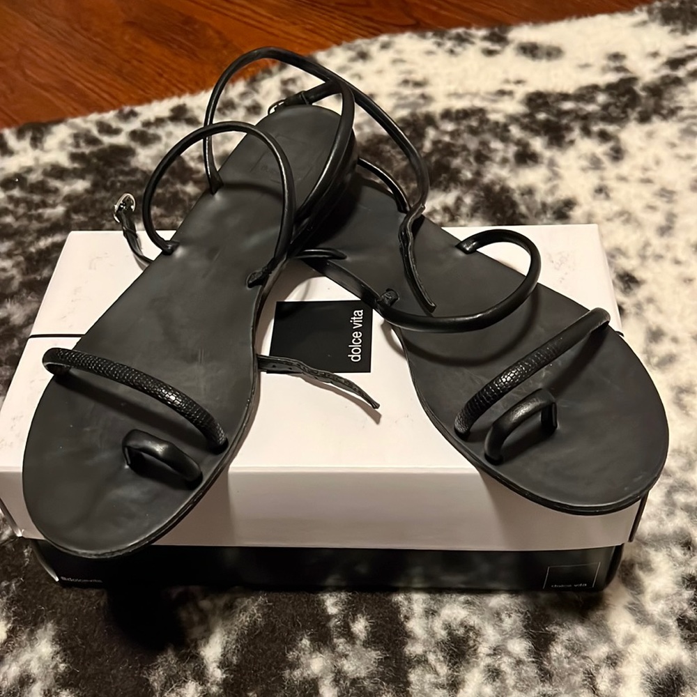Black flat sandals.